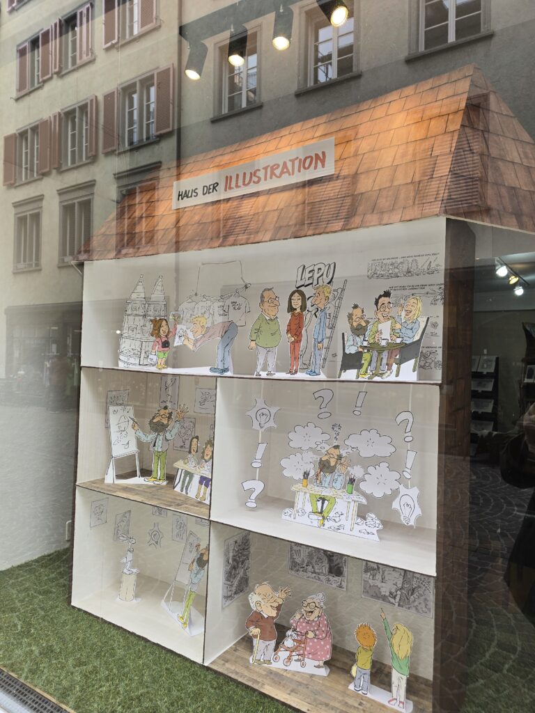 En la vaidrina da la localitad "Haus der Illustration" mussan Rolf ed Elena Giger lur gronda creativitad ed inschign manual.